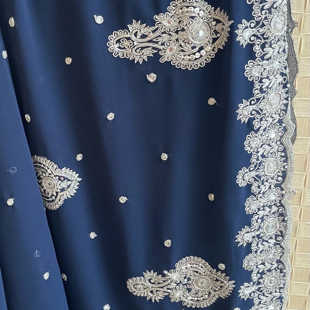Glamorous georgette saree in Navy Blue with silver embroidery.